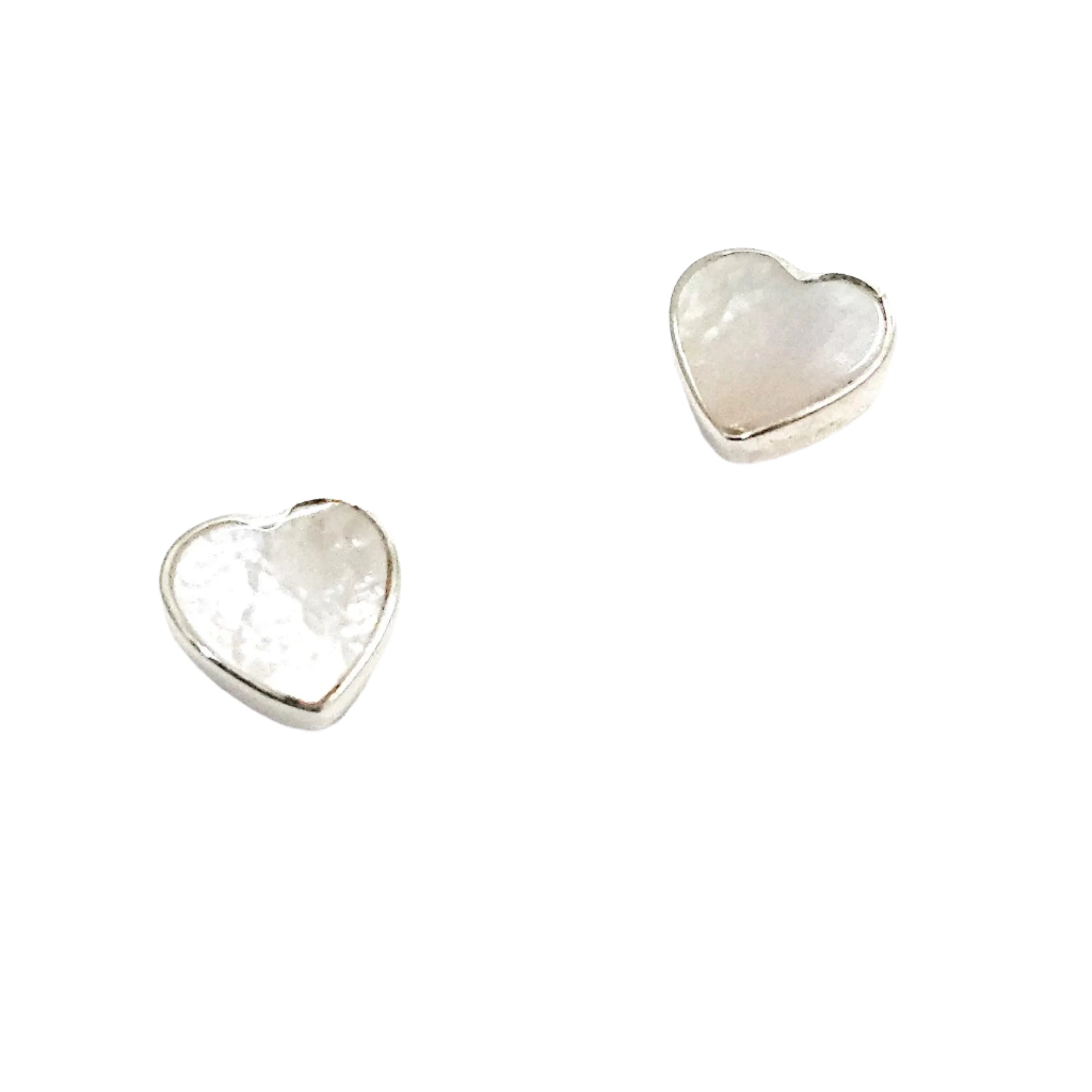 Pair of sterling silver heart-shaped stud earrings with mother-of-pearl inlays, showcasing their delicate and elegant design on a white background.